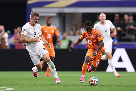 Norway's Alexander Soerloth (7) and Ivory Coast's Christ Inao Oulai (26) battle during the World Cup round of 32 soccer match