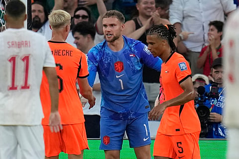 Netherlands goalkeeper Bart Verbruggen (1) is congratulated by teammate's Jan Paul van Hecke (6) and Nathan Ake (5) after making a save during the World Cup round of 32 soccer match between the Netherlands and Morocco in Guadalupe, near Monterrey, Mexico, Monday, June 29, 2026.