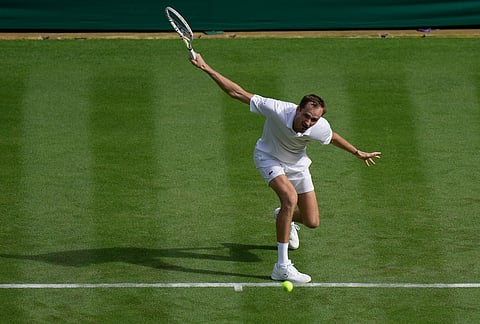Daniil Medvedev of Russia returns the ball to Marin Cilic of Croatia in their first round men's singles match at the Wimbledon Tennis Championships in London, Monday, June 29, 2026. 