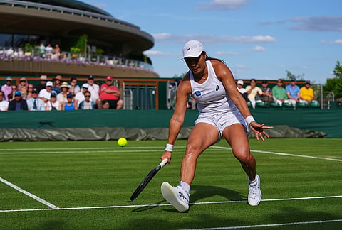 Janice Tjen of Indonesia returns the ball to Leylah Fernandez of Canada in their first round women's singles match at the Wimbledon Tennis Championships in London, Monday, June 29, 2026. 