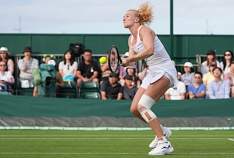 Katerina Siniakova of Czech Republic plays a backhand against Qinwen Zheng of China during their first round women's singles match at the Wimbledon Tennis Championships in London, Monday, June 29, 2026. 