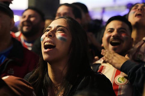 People watch the World Cup round of 32 soccer match between Paraguay and Germany in Asuncion