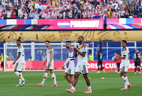 Germany's Jonathan Tah (4) and teammates acknowledge the crowd after a loss during the World Cup round of 32 soccer match between Germany and Paraguay in Foxborough, Mass., near Boston.