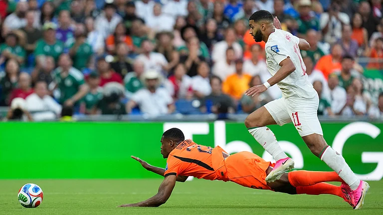 Netherlands' Denzel Dumfries (22) is tripped by Morocco's Ismael Saibari (11) during the World Cup round of 32 soccer match between the Netherlands and Morocco in Guadalupe, near Monterrey, Mexico, Monday, June 29, 2026. - (AP Photo/Dolores Ochoa)