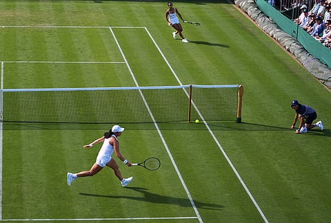 Leylah Fernandez of Canada, top, and Janice Tjen of Indonesia compete in their first round women's singles match at the Wimbledon Tennis Championships in London, Monday, June 29, 2026. 