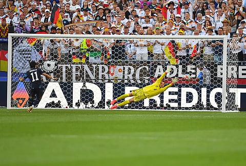 Paraguay's Mauricio (11) scores a goal during a shootout against Germany goalkeeper Manuel Neuer (1) during the World Cup round of 32 soccer match in Foxborough, Mass., near Boston.