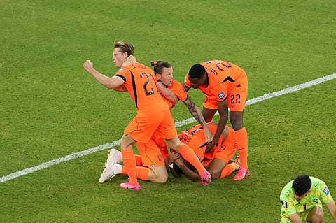 Netherlands' Cody Gakpo (11) celebrates with teammates after scoring their first goal during the World Cup round of 32 soccer match between the Netherlands and Morocco in Guadalupe, near Monterrey, Mexico, Monday, June 29, 2026.