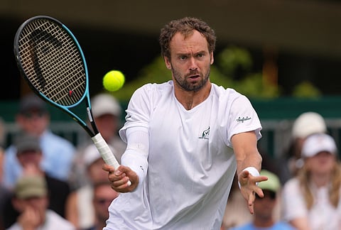 Roman Safiullin of Russia returns the ball to Andrey Rublev of Russia during the men's singles at the Wimbledon Tennis Championships in London, Monday, June 29, 2026.