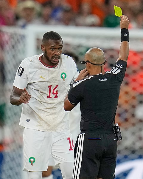 Morocco's Issa Diop (14) receives a yellow card from referee Wilton Sampaio of Brazil during the World Cup round of 32 soccer match between the Netherlands and Morocco in Guadalupe, near Monterrey, Mexico, Monday, June 29, 2026.