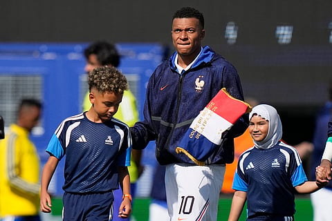 France's Kylian Mbappe (10) looks on after the national anthem during the World Cup round of 32 soccer match 