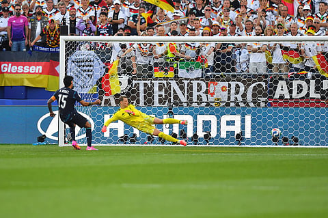 Paraguay's Gustavo Gomez (15) scores on Germany goalkeeper Manuel Neuer (1) in a shootout during the World Cup round of 32 soccer match between Germany and Paraguay in Foxborough
