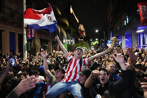 Fans celebrate after watching the World Cup round of 32 soccer match between Paraguay and Germany in Asuncion
