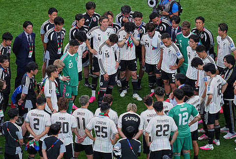 Japan players react at the end the World Cup round of 32 soccer match between Brazil and Japan in Houston.