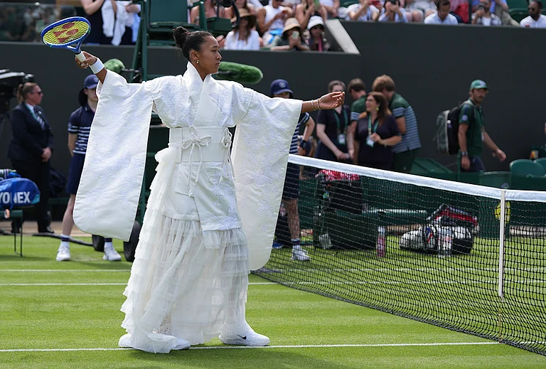 Naomi Osaka of Japan walks into the court to play against Elsa Jacquemot of France in their first round women's singles match at the Wimbledon Tennis Championships in London, Monday, June 29, 2026. - | Photo: AP/Maja Smiejkowska
