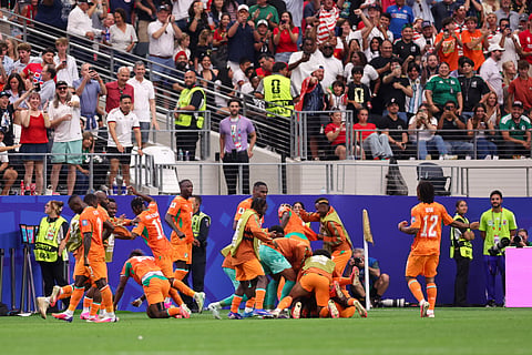 Ivory Coast players celebrate their side's opening goal by Amad Diallo (15) during the World Cup round of 32 soccer match