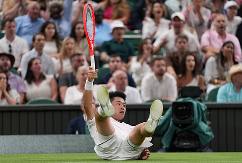 Yibing Wu of China falls over during the men's singles match against Novak Djokovic of Serbia at the Wimbledon Tennis Championships in London, Monday, June 29, 2026.