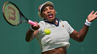 | Photo; AP/Kin Cheung : Serena Williams of the United States plays a return during a practice session ahead of the Wimbledon Tennis Championships, in London.