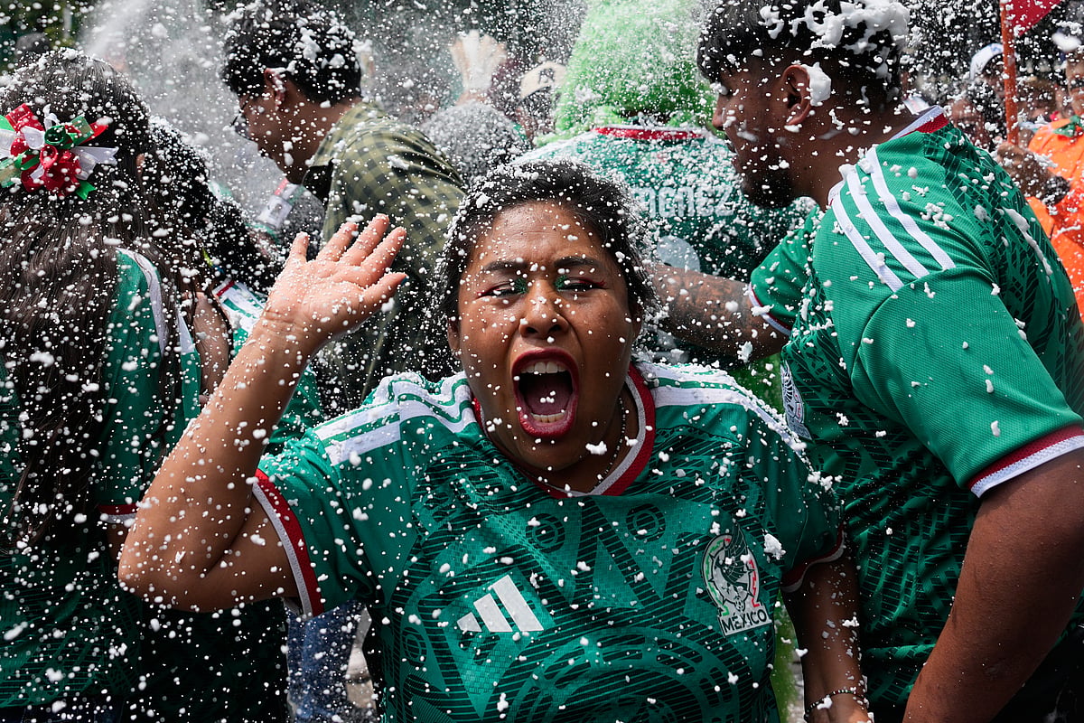 Soccer fans get revved up at a watch party on Reforma Ave., near the Angel of Independence monument, for the World Cup soccer match between Mexico and Ecuador, in Mexico City - AP/Marco Ugarte
