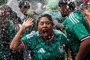 AP/Marco Ugarte : Soccer fans get revved up at a watch party on Reforma Ave., near the Angel of Independence monument, for the World Cup soccer match between Mexico and Ecuador, in Mexico City