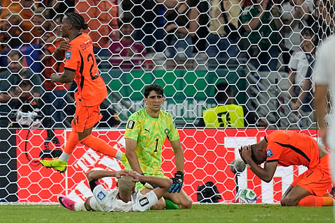 Netherlands' Cody Gakpo, right, reacts after scoring his team's first goal during the World Cup round of 32 soccer match between the Netherlands and Morocco in Guadalupe, near Monterrey, Mexico, Monday, June 29, 2026. 