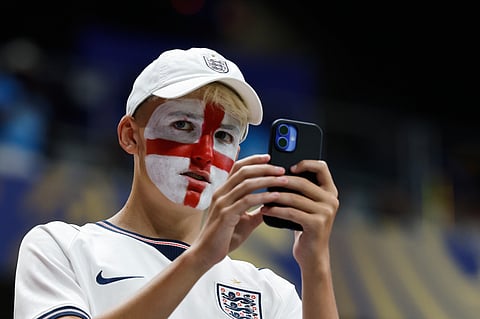 A fan of England waits for the start of the World Cup round of 32 soccer match between England and Congo in Atlanta