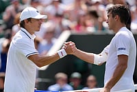 | Photo: AP/Kin Cheung : Roman Andres Burruchaga of Argentina and Alex de Minaur of Australia, left, shake hands after the men's singles match at the Wimbledon Tennis Championships in London, Tuesday, June 30, 2026.