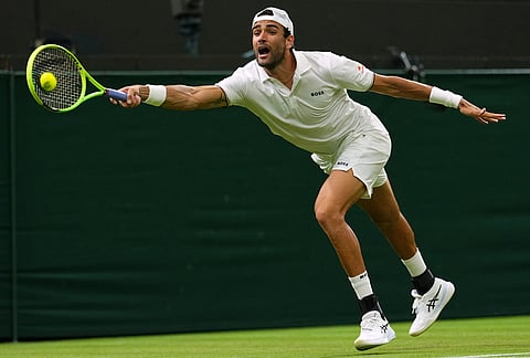 Matteo Berrettini of Italy returns the ball to Stan Wawrinka of Switzerland in their first round men's singles match at the Wimbledon Tennis Championships in London, Tuesday, June 30, 2026.
