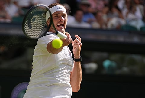 Alexander Zverev of Germany plays a forehand against Alexander Blockx of Belgium in their first round men's singles match at the Wimbledon Tennis Championships in London, Tuesday, June 30, 2026. 