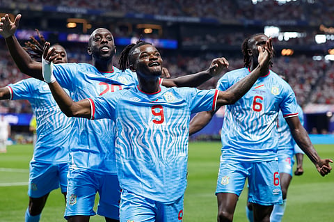 Congo's Brian Cipenga (9) celebrates with teammates after scoring their first goal during the World Cup round of 32 soccer match between England and Congo in Atlanta.