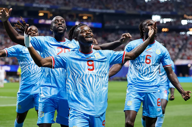 Congos Brian Cipenga (9) celebrates with teammates after scoring their first goal during the World Cup round of 32 soccer match between England and Congo in Atlanta.