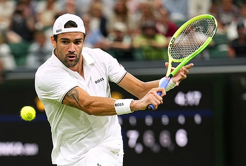Matteo Berrettini of Italy returns the ball to Stan Wawrinka of Switzerland in their first round men's singles match at the Wimbledon Tennis Championships in London, Tuesday, June 30, 2026. 