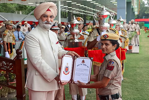 Delhi LG Taranjit Singh Sandhu felicitates a police official during the Delhi Police Commissionerate Day, in New Delhi. 