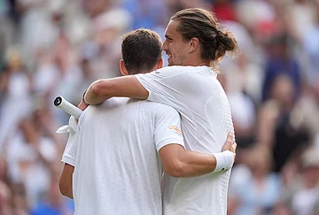 | Photo: AP/Maja Smiejkowska : Winner Alexander Zverev of Germany, right, hugs Alexander Blockx of Belgium after their first round men's singles match, at the Wimbledon Tennis Championships in London, Tuesday, June 30, 2026.