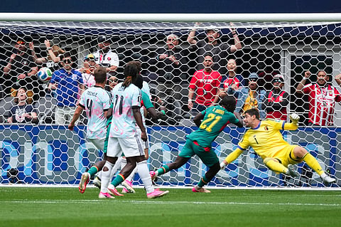 Senegal's Habib Diarra (21) scores their first goal against Belgium goalkeeper Thibaut Courtois (1) during the World Cup round of 32 soccer match between Belgium and Senegal