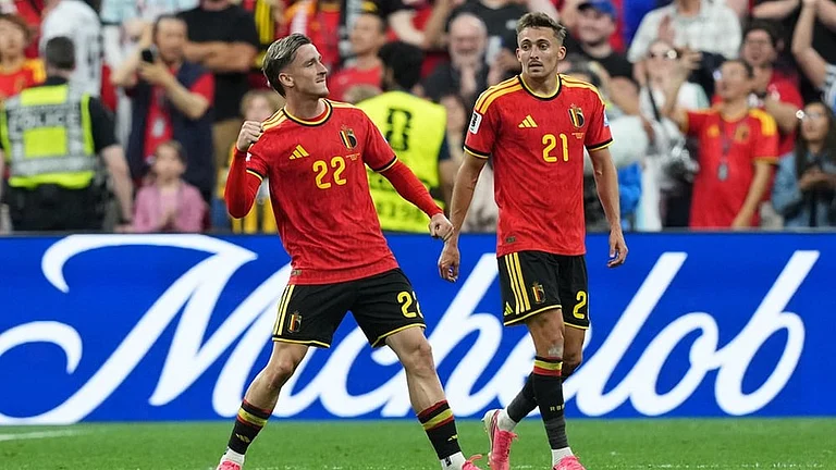 Belgium's Alexis Saelemaekers (22) celebrates his goal with Belgium's Timothy Castagne (21) during the second half of a World Cup Group D soccer match, in Vancouver, British Columbia. - | Photo: Ethan Cairn/The Canadian Press via AP