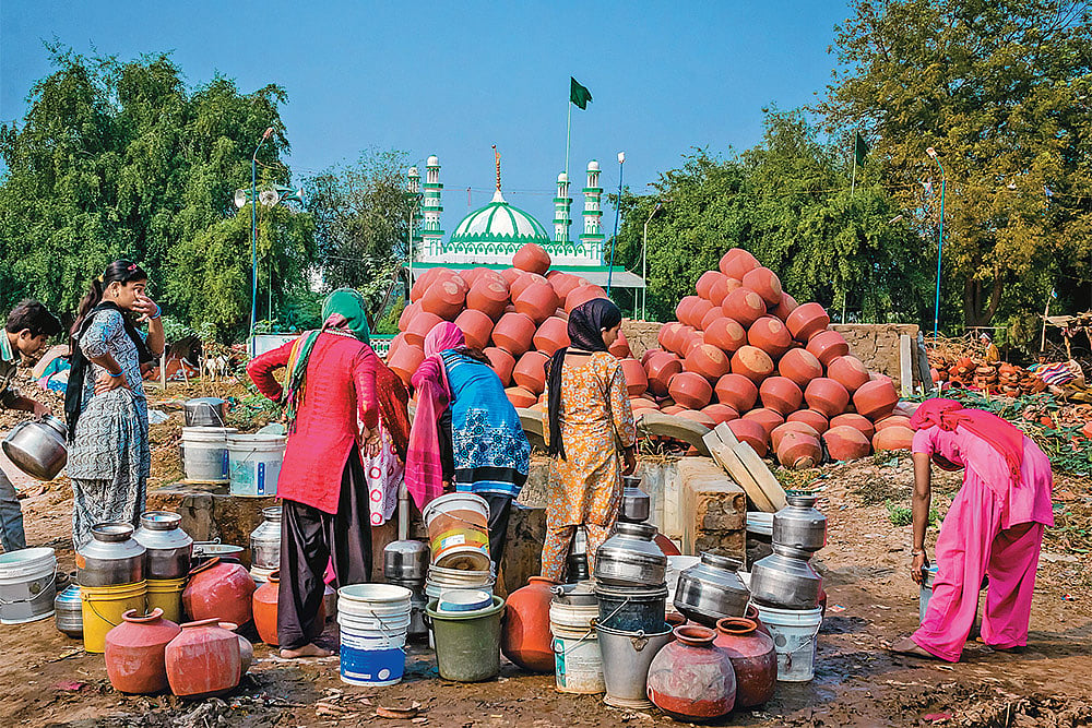 Summer Woes: Women filling water from a well in Ahmedabad’s Makarba area 