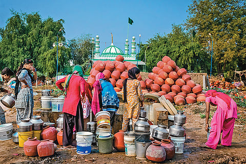 Summer Woes: Women filling water from a well in Ahmedabad’s Makarba area 