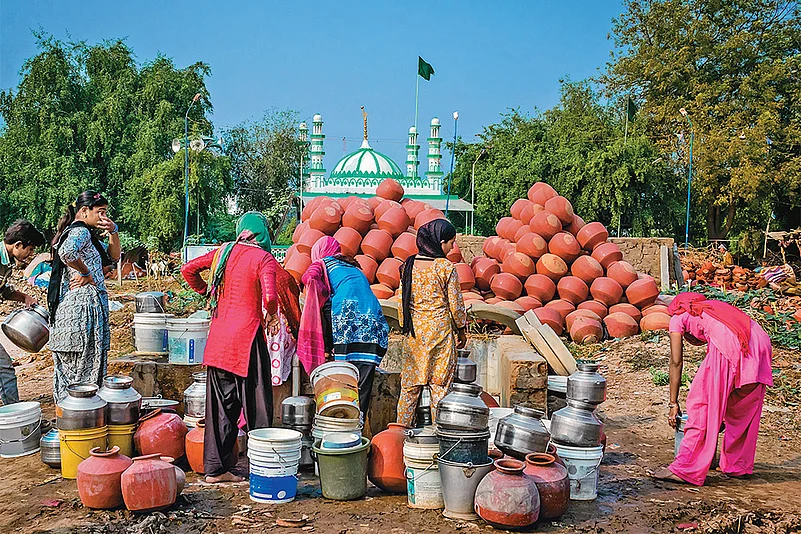 Summer Woes: Women filling water from a well in Ahmedabad’s Makarba area