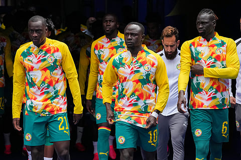 Senegal's Habib Diarra (21), Sadio Mane (10) and Pathe Ciss (6) take the field for warm ups during the World Cup round of 32 soccer match between Belgium and Senegal in Seattle
