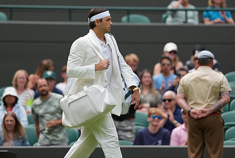 Taylor Fritz of the United States walks into court 1 to play against Dusan Lajovic of Serbia in their first round men's singles match at the Wimbledon Tennis Championships in London, Tuesday, June 30, 2026. 