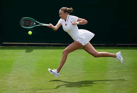 Amanda Anisimova of the United States plays a return to Lina Gjorcheska of North Macedonia during their women's singles match at the Wimbledon Tennis Championships in London, Tuesday, June 30, 2026.