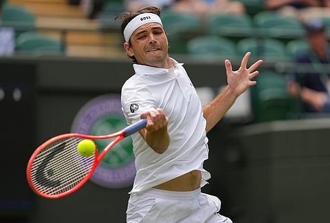 Taylor Fritz of the United States plays a forehand against Dusan Lajovic of Serbia in their first round men's singles match at the Wimbledon Tennis Championships in London, Tuesday, June 30, 2026.