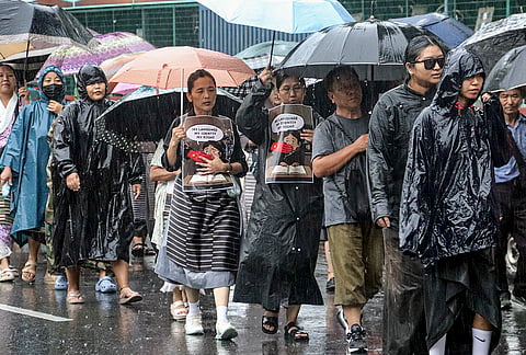 Members of the Tibetan Youth Congress (TYC) stage a protest amid rain on the 105th founding anniversary of the Communist Party of China, in Dehradun, Uttarakhand.