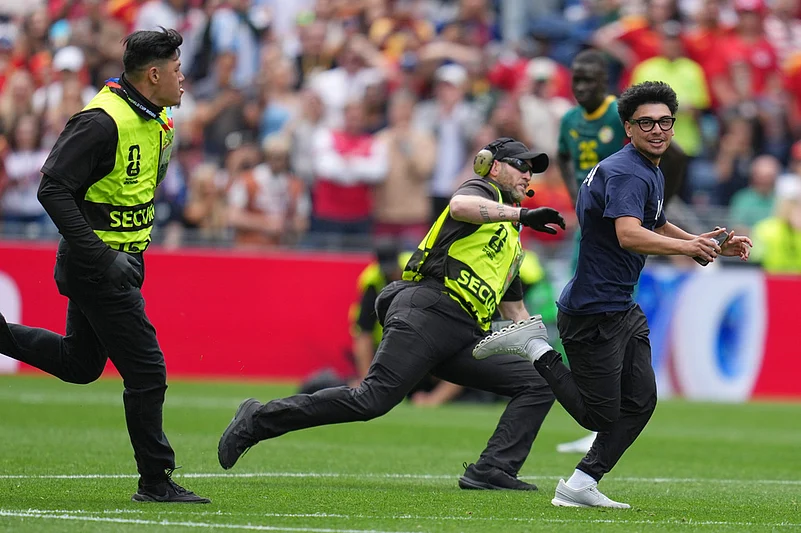 A fan runs onto the pitch during the World Cup round of 32 soccer match between Belgium and Senegal in Seattle