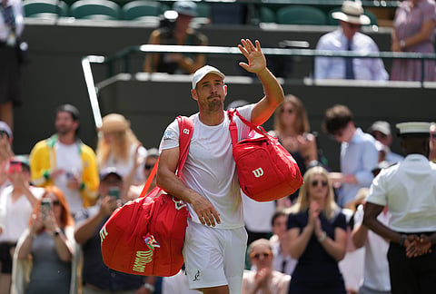 Dusan Lajovic of Serbia waves as she leaves the court after losing to Taylor Fritz of the United States in their first round men's singles match at the Wimbledon Tennis Championships in London, Tuesday, June 30, 2026. 