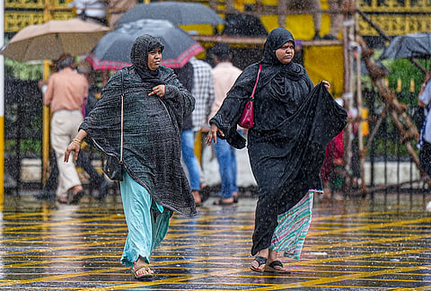 People make their way amid rain, in Mumbai, Maharashtra, Wednesday, July 1, 2026. Several parts of Mumbai received over 100 mm of rainfall resulting in waterlogging in a few low-lying areas. 