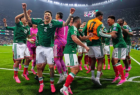 Mexico players react following the World Cup round of 32 soccer match between Mexico and Ecuador in Mexico City.