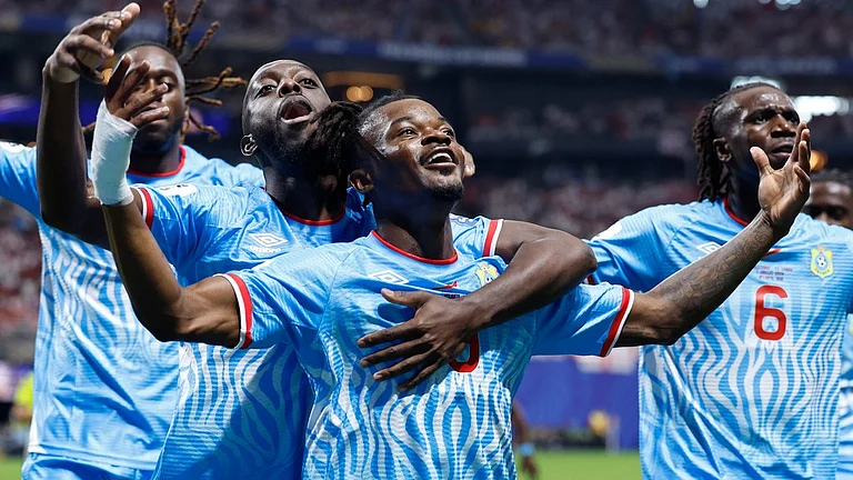 Congo's Brian Cipenga (9) celebrates with teammates after scoring their first goal during the World Cup round of 32 soccer match between England and Congo in Atlanta. - AP Photo/Butch Dill
