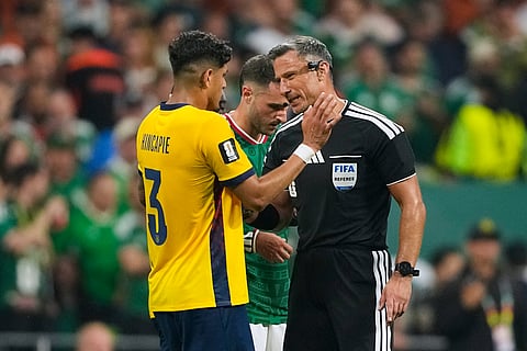 Referee Slavko Vincic of Slovenia speaks to Ecuador's Piero Hincapie (3) before sending him from the field during the World Cup round of 32 soccer match between Mexico and Ecuador in Mexico City, Tuesday, June 30, 2026.
