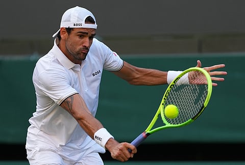 Matteo Berrettini of Italy plays a volley against Stan Wawrinka of Switzerland in their first round men's singles match at the Wimbledon Tennis Championships in London, Tuesday, June 30, 2026. 